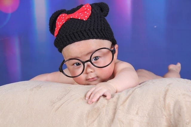 A small baby wearing glasses