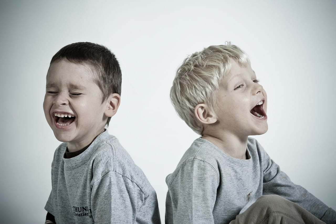 Students joyfully laughing together, promoting emotional well-being and connection