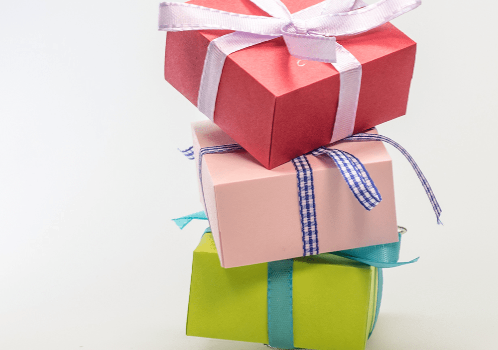Colorful stacked gift boxes representing support and resources for schools
