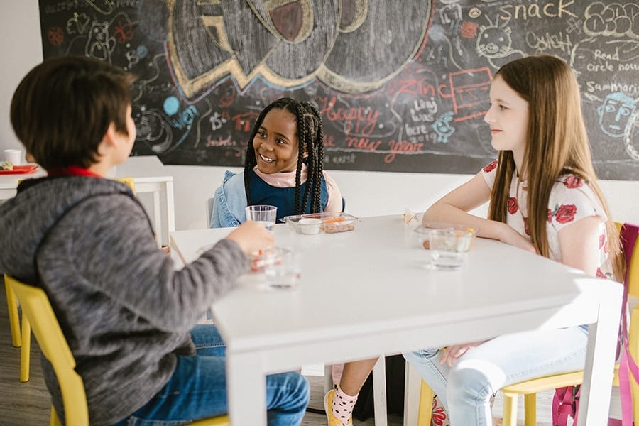 Students engaging in social skills activities at a classroom table