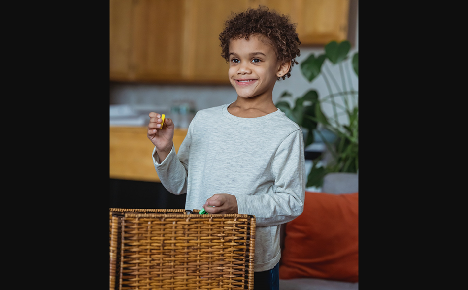 child taking plastic letter out of basket