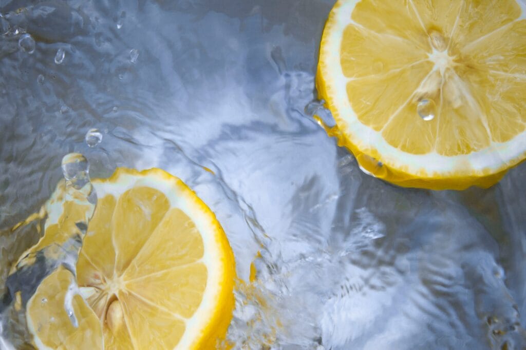 Sliced lemons floating in water representing refreshing ideas