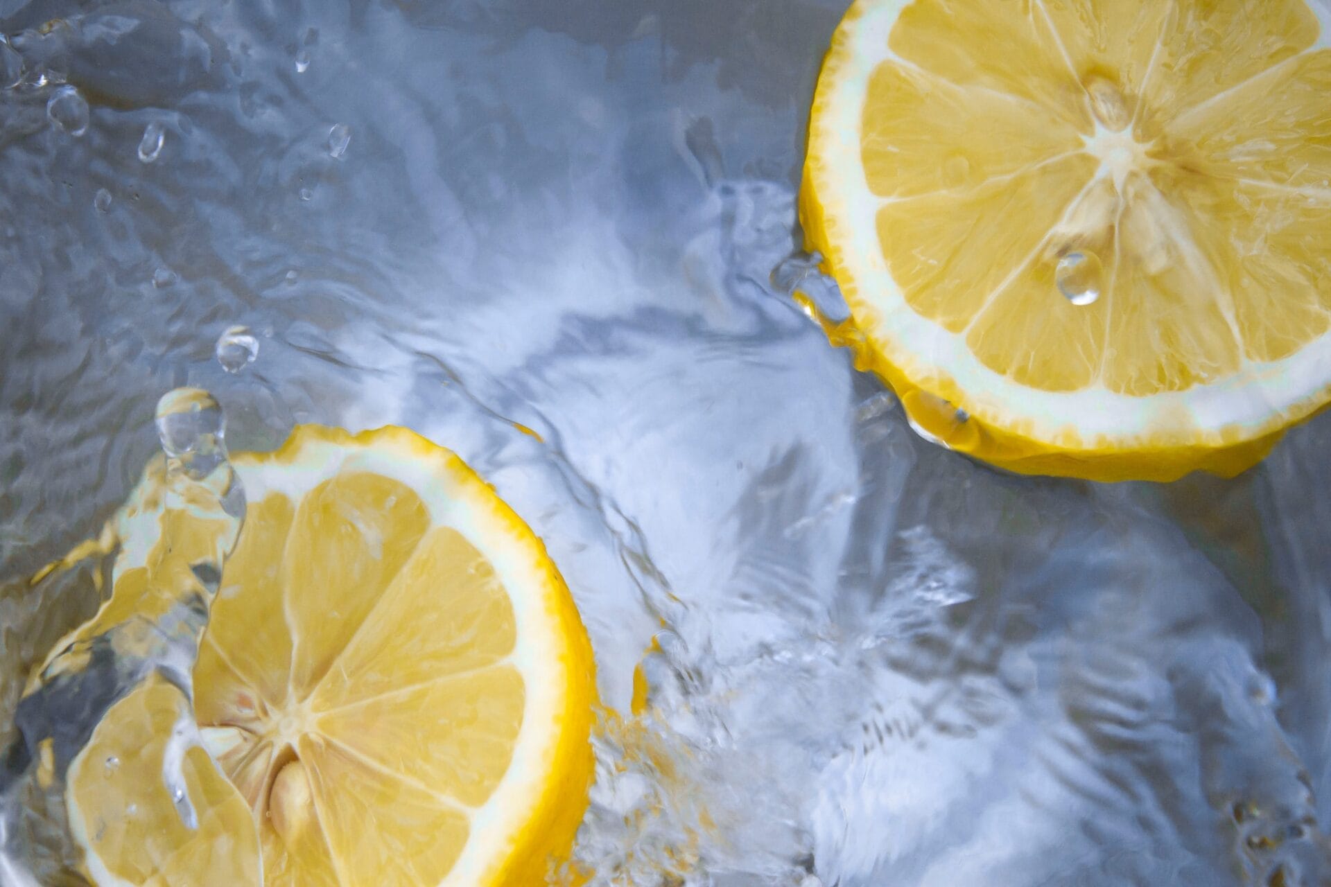 Sliced lemons floating in water representing refreshing ideas