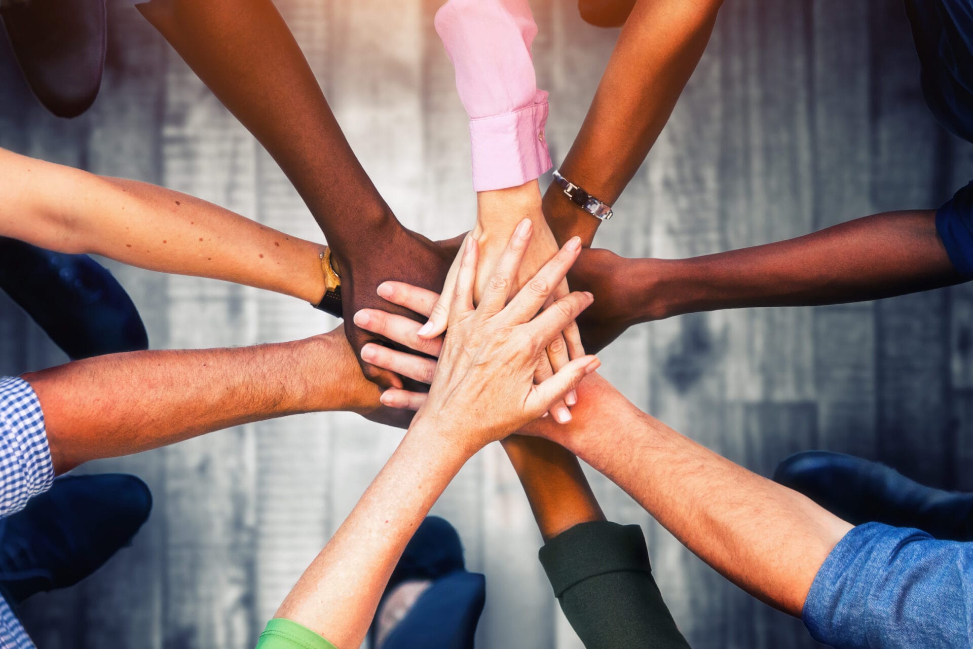 Diverse hands coming together, symbolizing collaboration and support