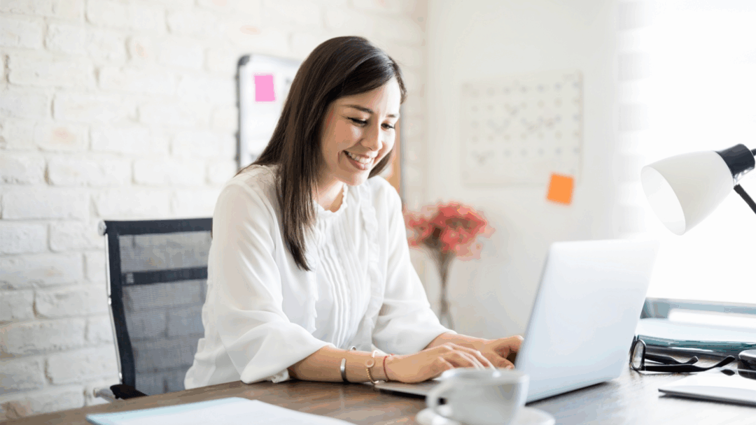 Teletherapist engaging with online therapy tools on laptop in modern office setting