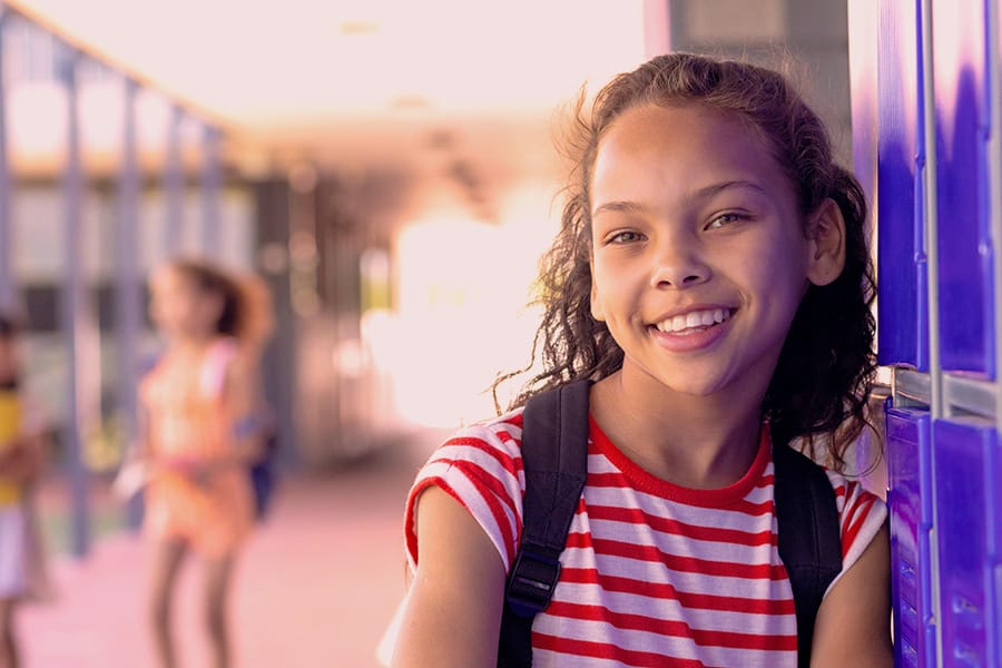 Smiling student at school locker