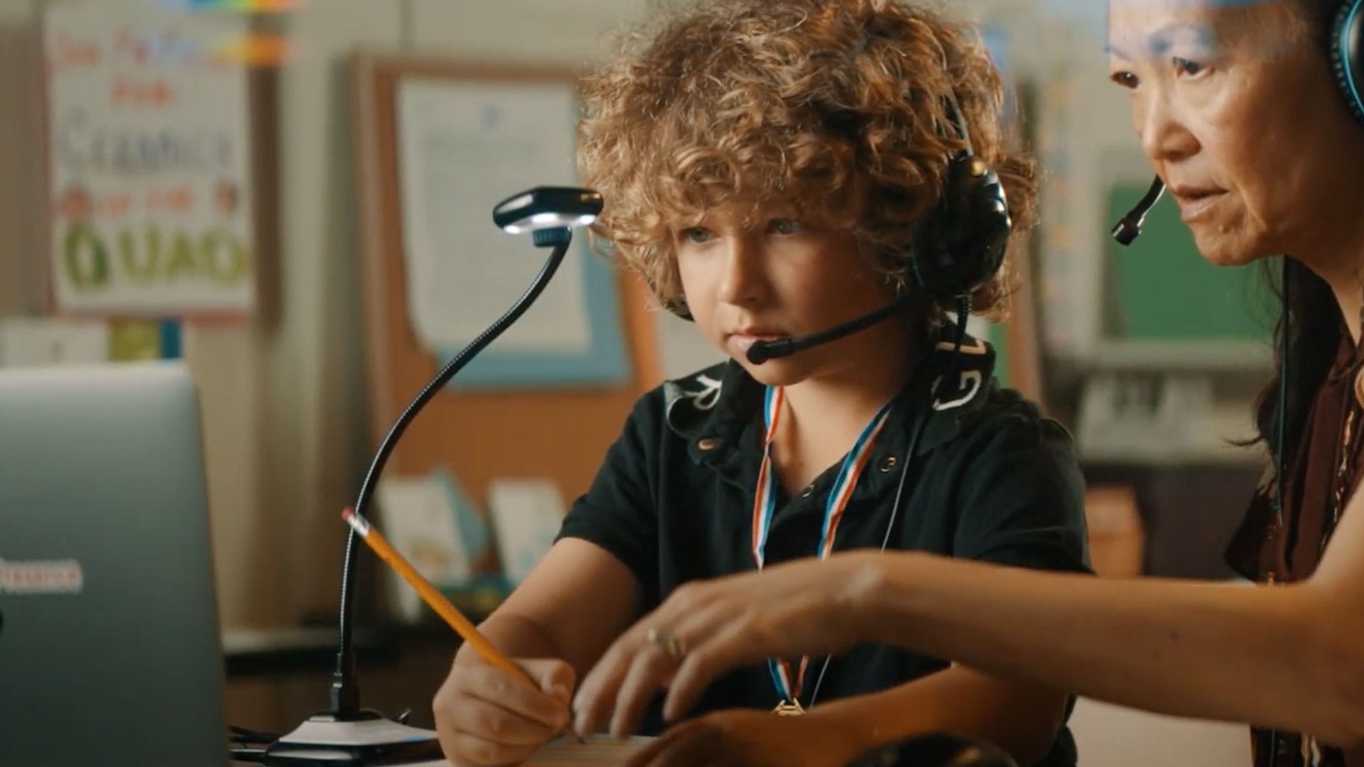 Student engaged in online learning with a female teletherapist