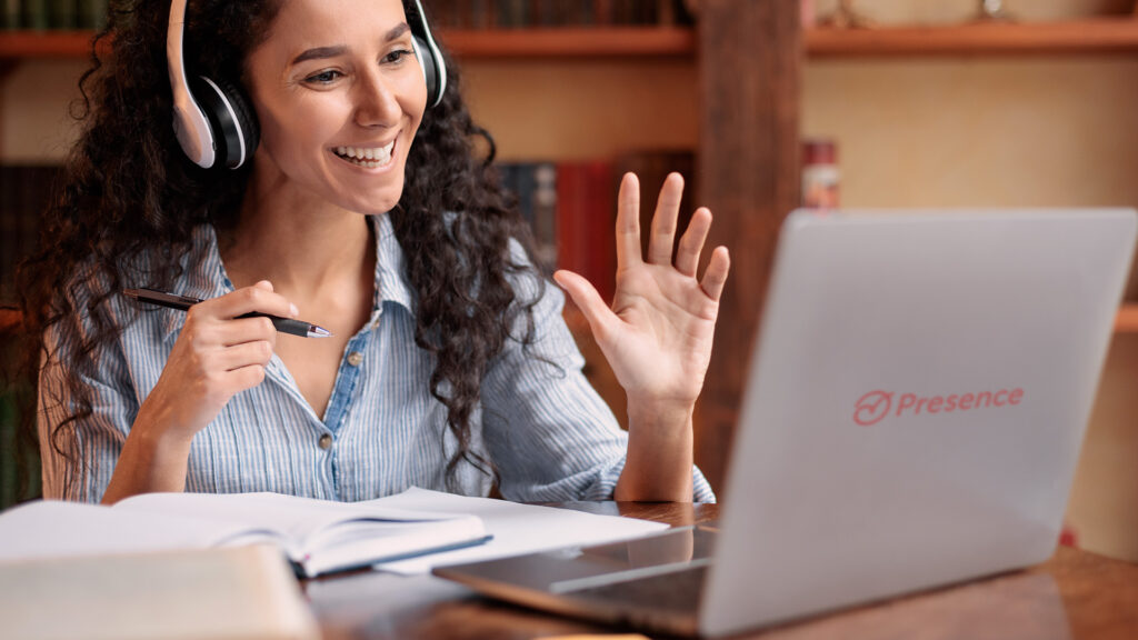 Smiling teletherapist engaging in online therapy session using a laptop