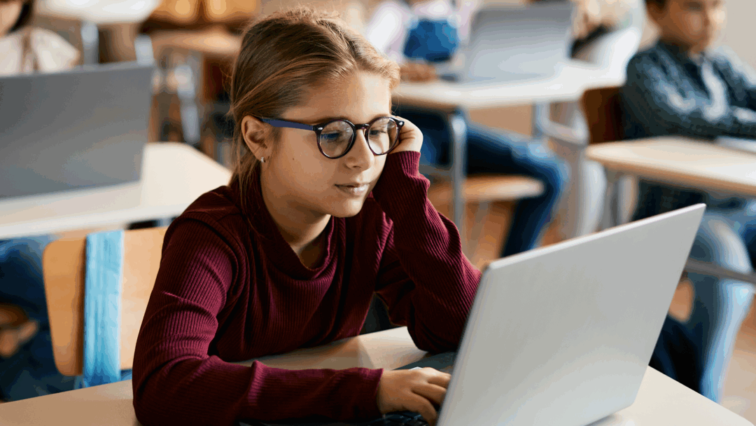 A student engaged with online learning in a classroom setting