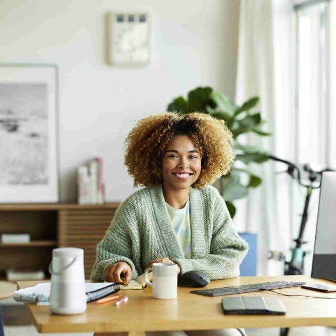 Teletherapist seated at a desk with digital tools