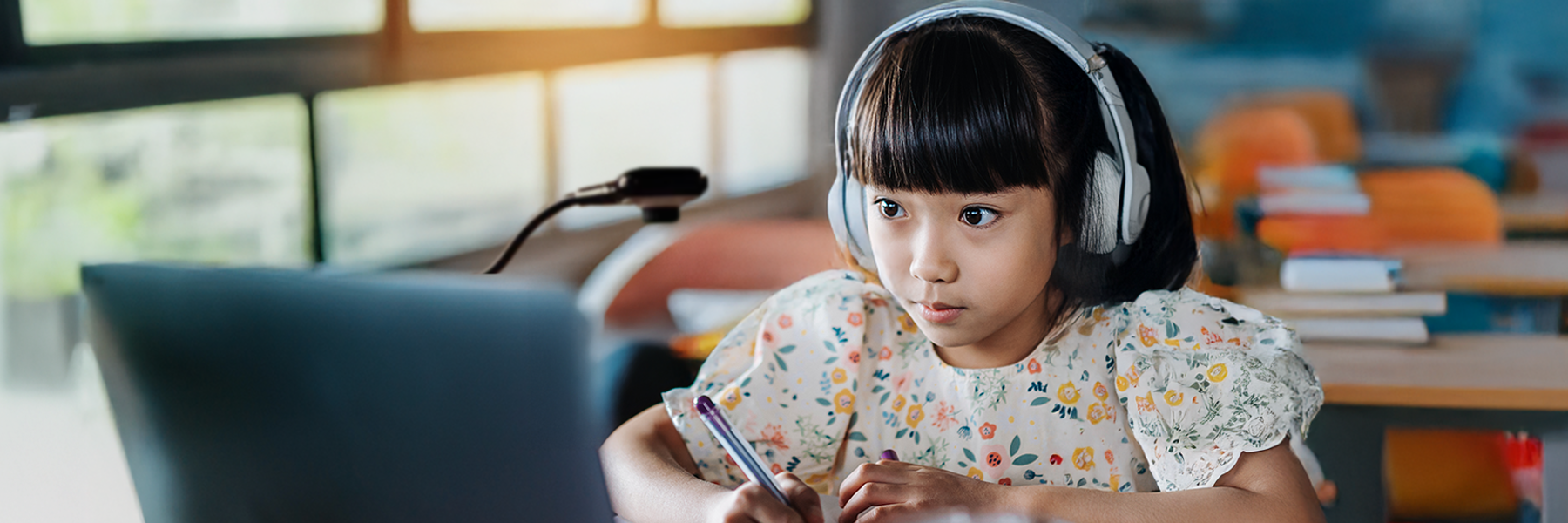 A student engaged with online learning in a classroom setting