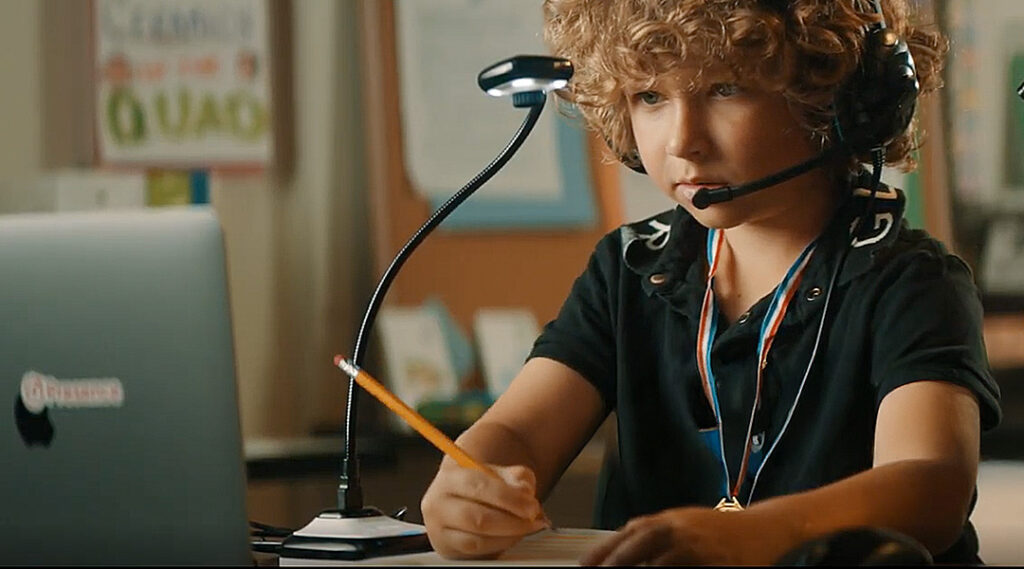 A student engaged with online learning in a classroom setting
